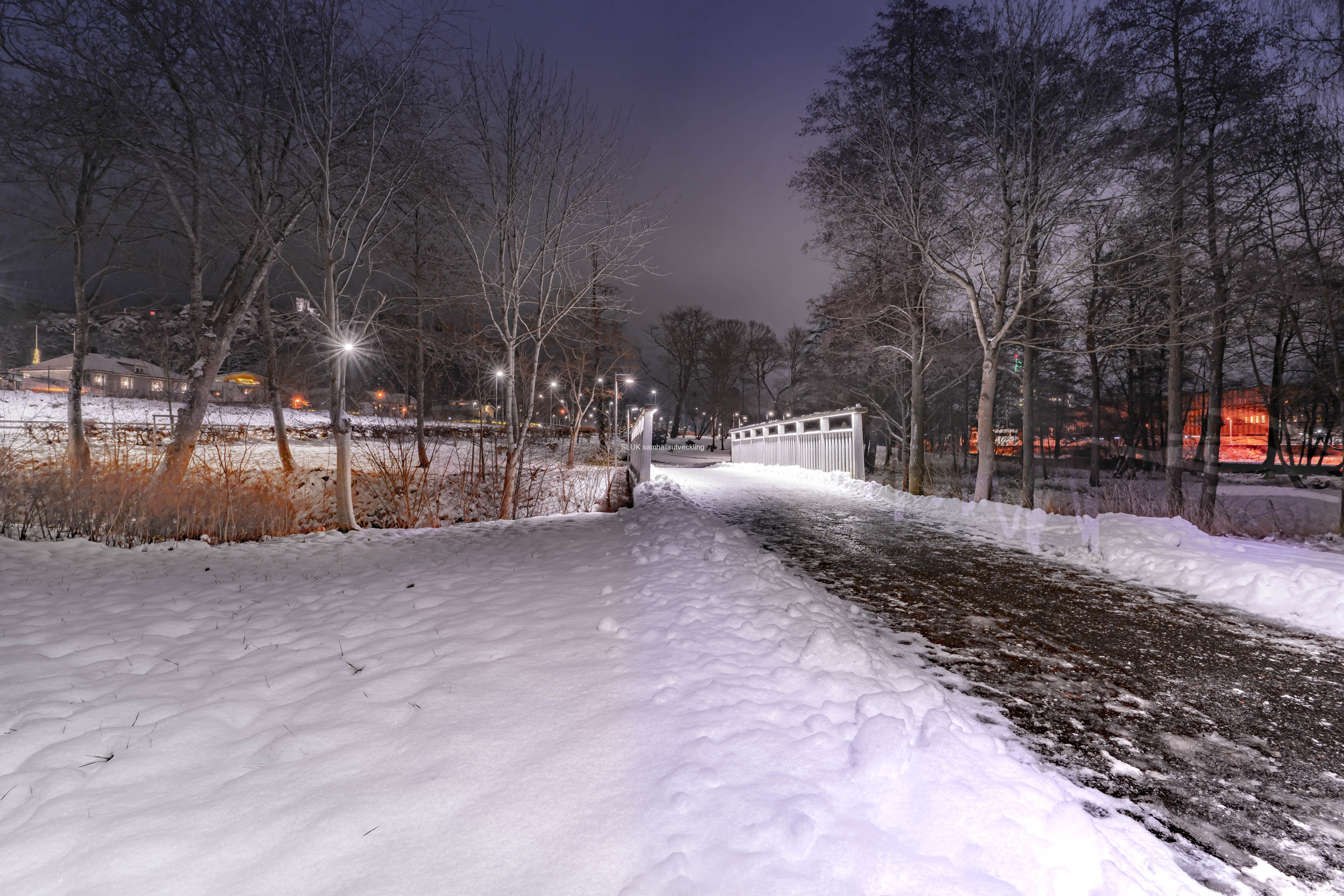 Under veckan fick vi en del snö och jag passade på att fotografera på lördag kväll i Stadsparken. Gångbron över Säveån nära stationen är belyst.
