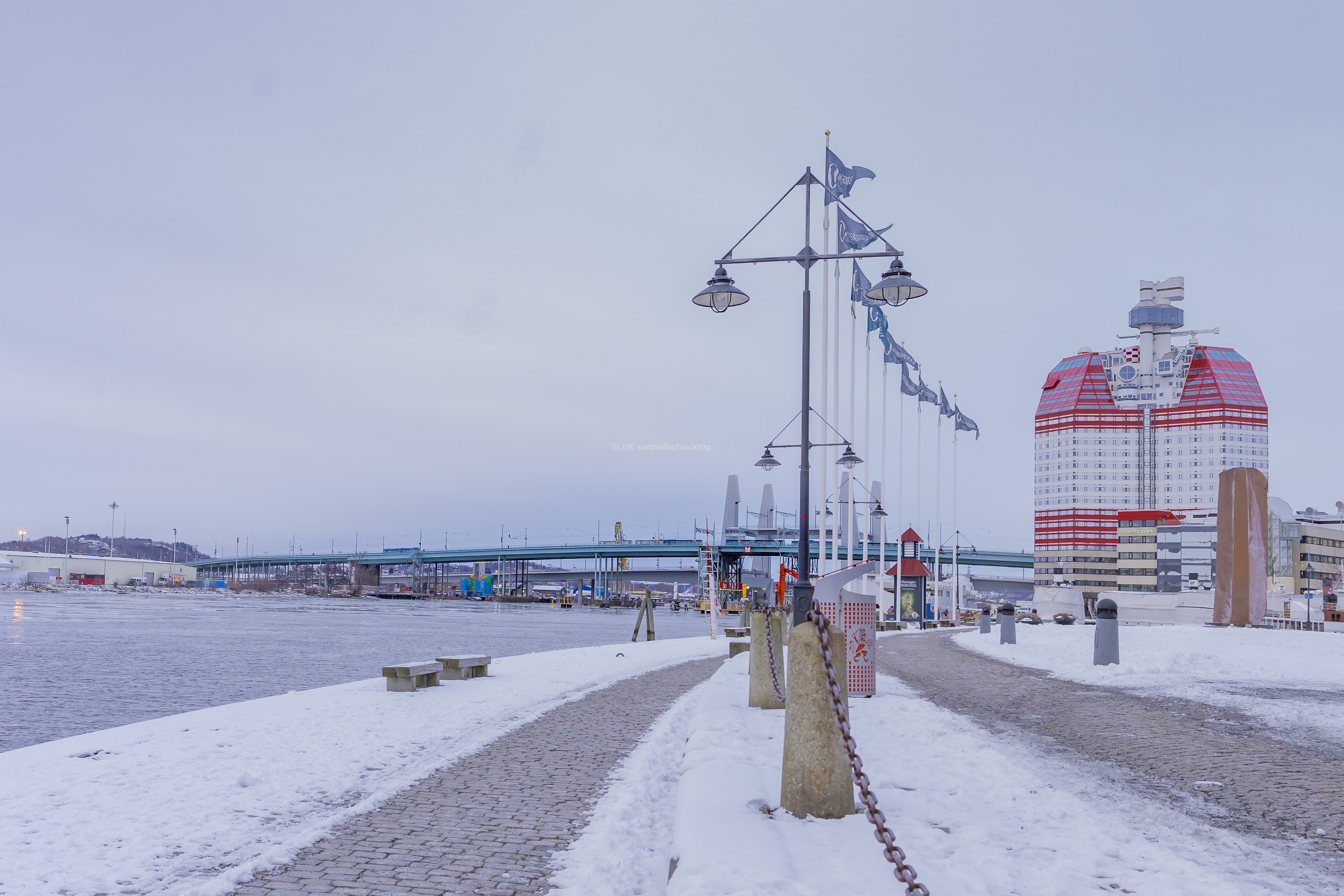 Jag promenerar mot Gullbergsvass. Till höger syns Läppstiftet och Götaälvbron syns i över älven. Bakom Götaälvbron tornar Hisingsbrons Pyloner.